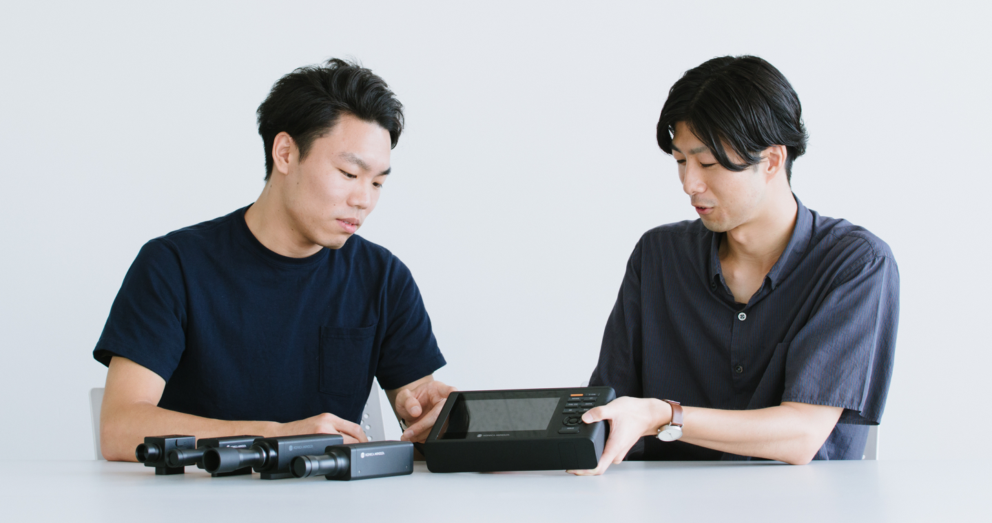 Photograph: Jun Shibayama and Naoaki Iwamatsu being interviewed in front of a mock-up