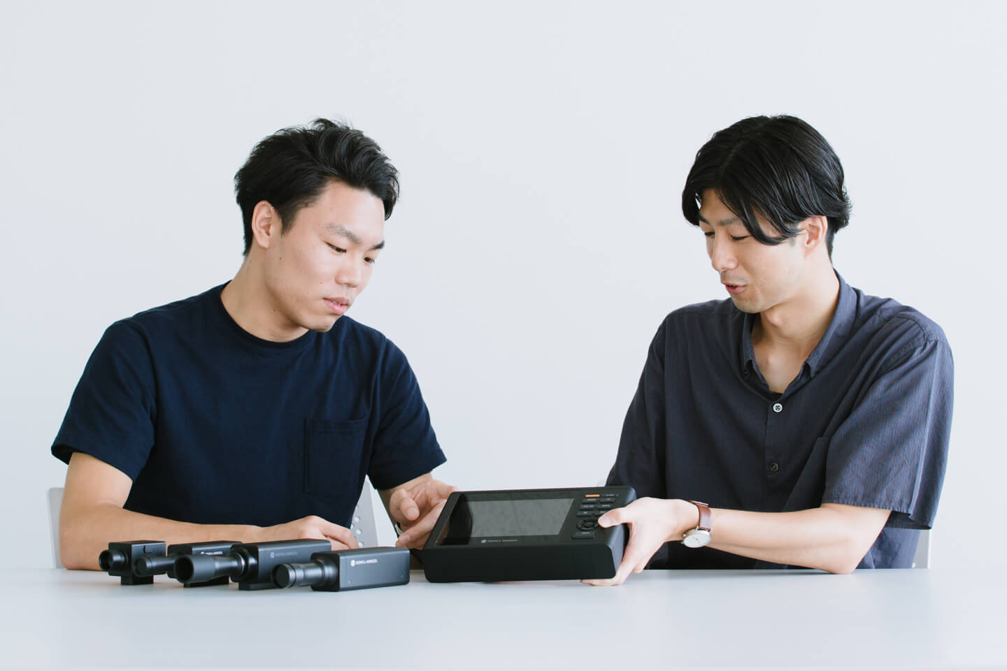 Photograph: Jun Shibayama and Naoaki Iwamatsu being interviewed in front of a mock-up