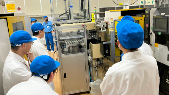 Participants touring production facilities