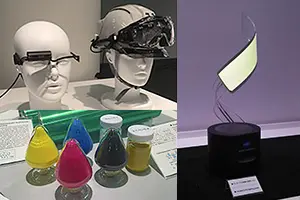 展示ブースの写真。ヘッドマウントディスプレイと色とりどりの液体が入ったフラスコ、曲がる有機ELパネル