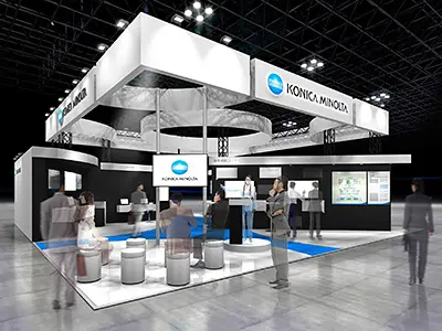 展示会ブースの完成イメージ図。中央に円形のカウンター、周囲に製品展示と大型ディスプレイを配置